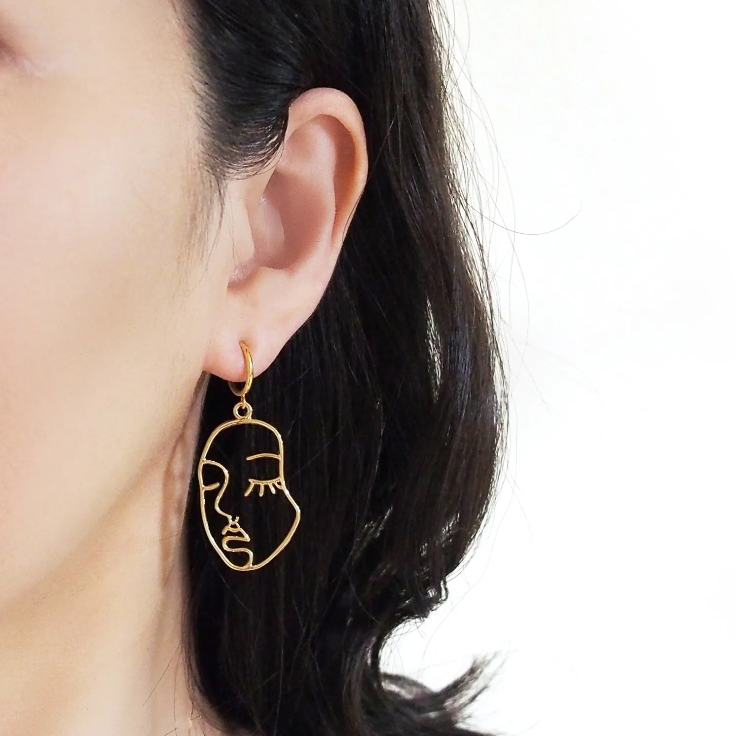 Gold human face clip on hoop earrings