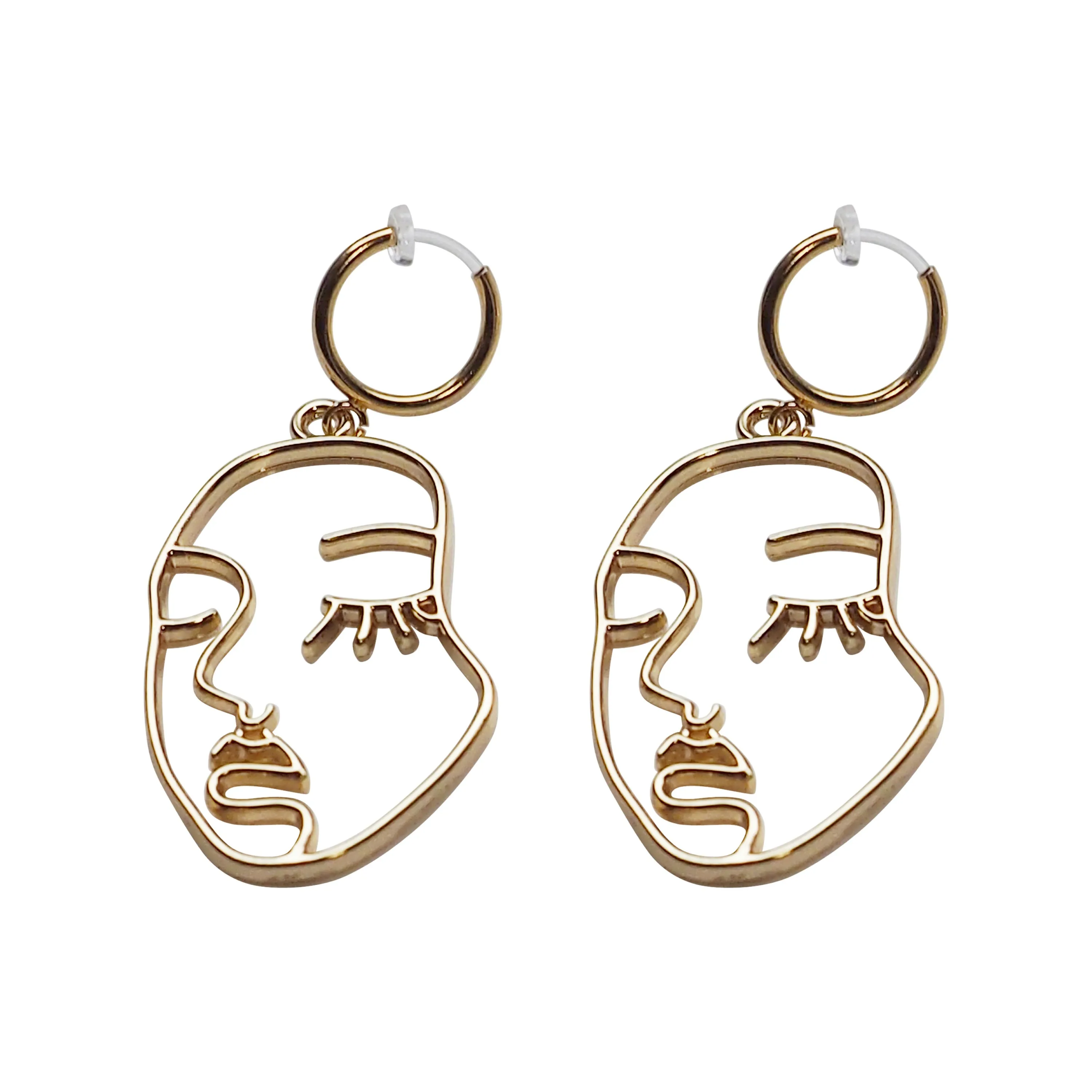 Gold human face clip on hoop earrings